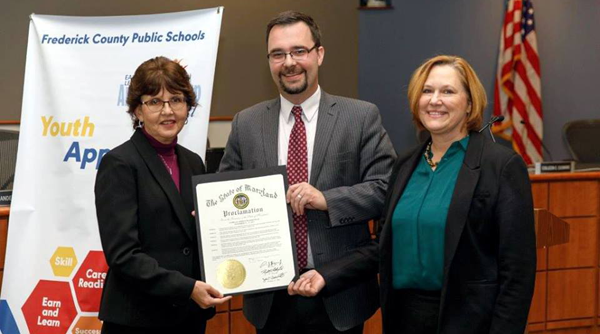 Deputy Assistant Secretary Brandon Butler (center) presented Frederick County Public Schools Superintendent Dr. Teresa Alban (left) and Dr. Kristine Pearl, supervisor, career and technology education (right) with a proclamation of National Apprenticeship Week
